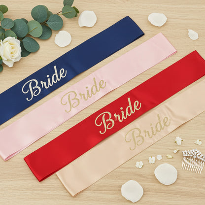 Four satin sashes with 'Bride' text on a wooden surface with decorative elements.