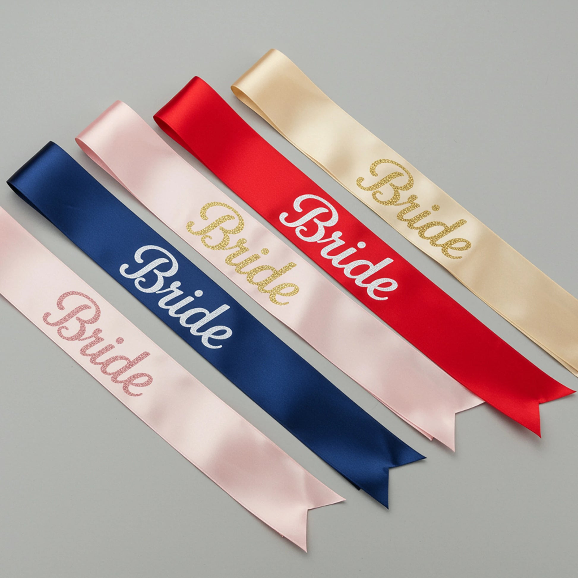 Set of satin sashes with 'Bride' text in various colors on a gray background
