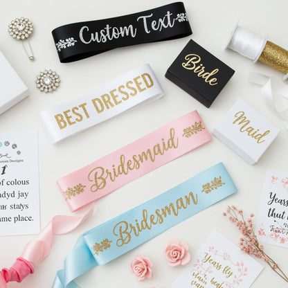 Collection of customizable sashes with text like 'Bridesmaid', 'Best Dressed', and 'Maid' on a decorative background.