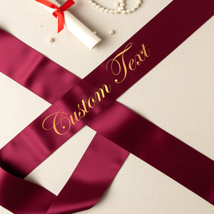 Maroon ribbon with 'Custom Text' in gold on a light background