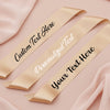 Three gold ribbons with customizable text on a pink fabric background