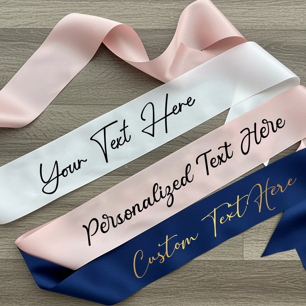 Three ribbons with customizable text on a wooden surface